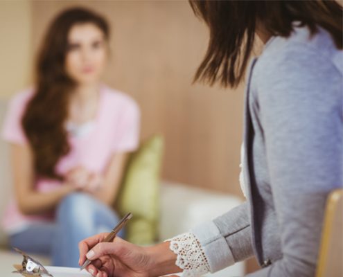 Young woman talking to counsellor