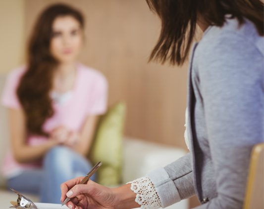 Young woman talking to counsellor
