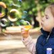 Little girl blowing bubbles