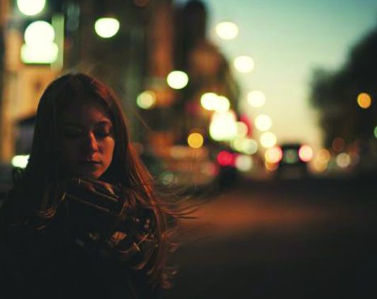 Young woman on the street at night