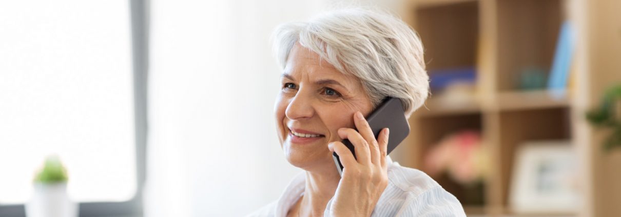 Older lady smiling and talking on the phone