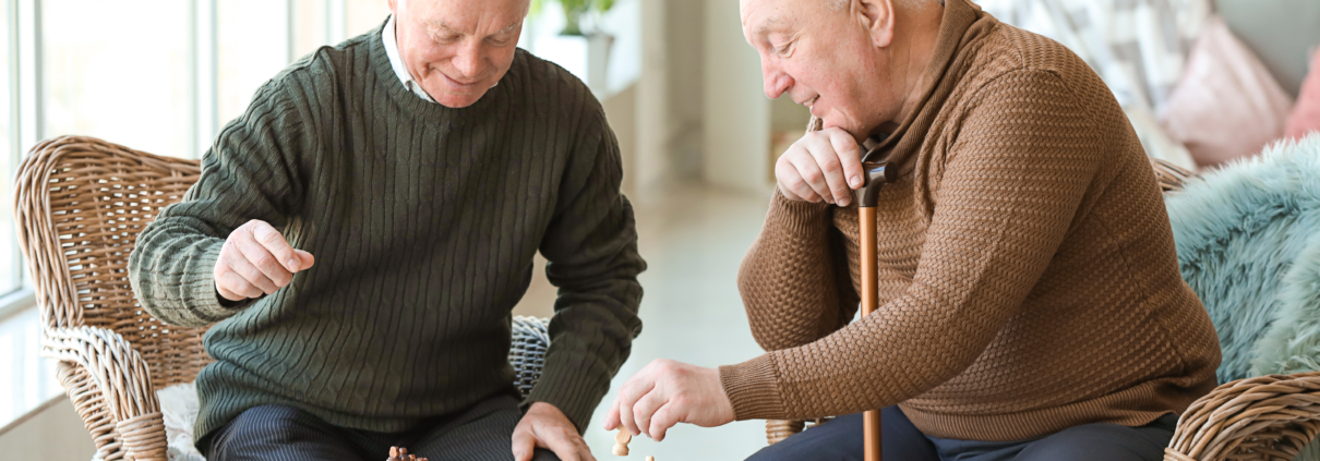 Two men playing chess in a care home