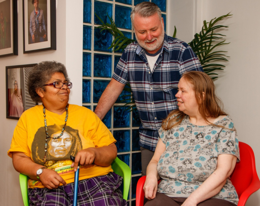 Three people with learning disabilities talking to each other
